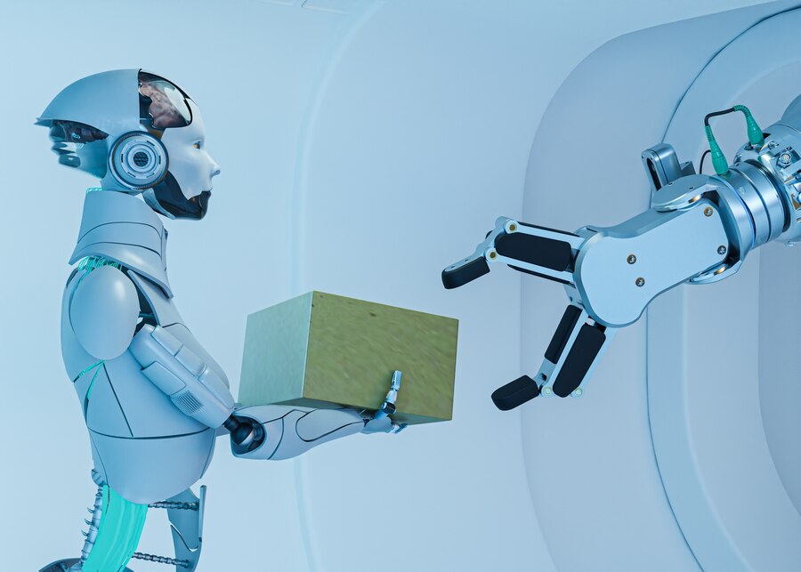 A humanoid robot hands a box to a mechanical arm in a futuristic, sleek environment, showcasing collaboration between machines.