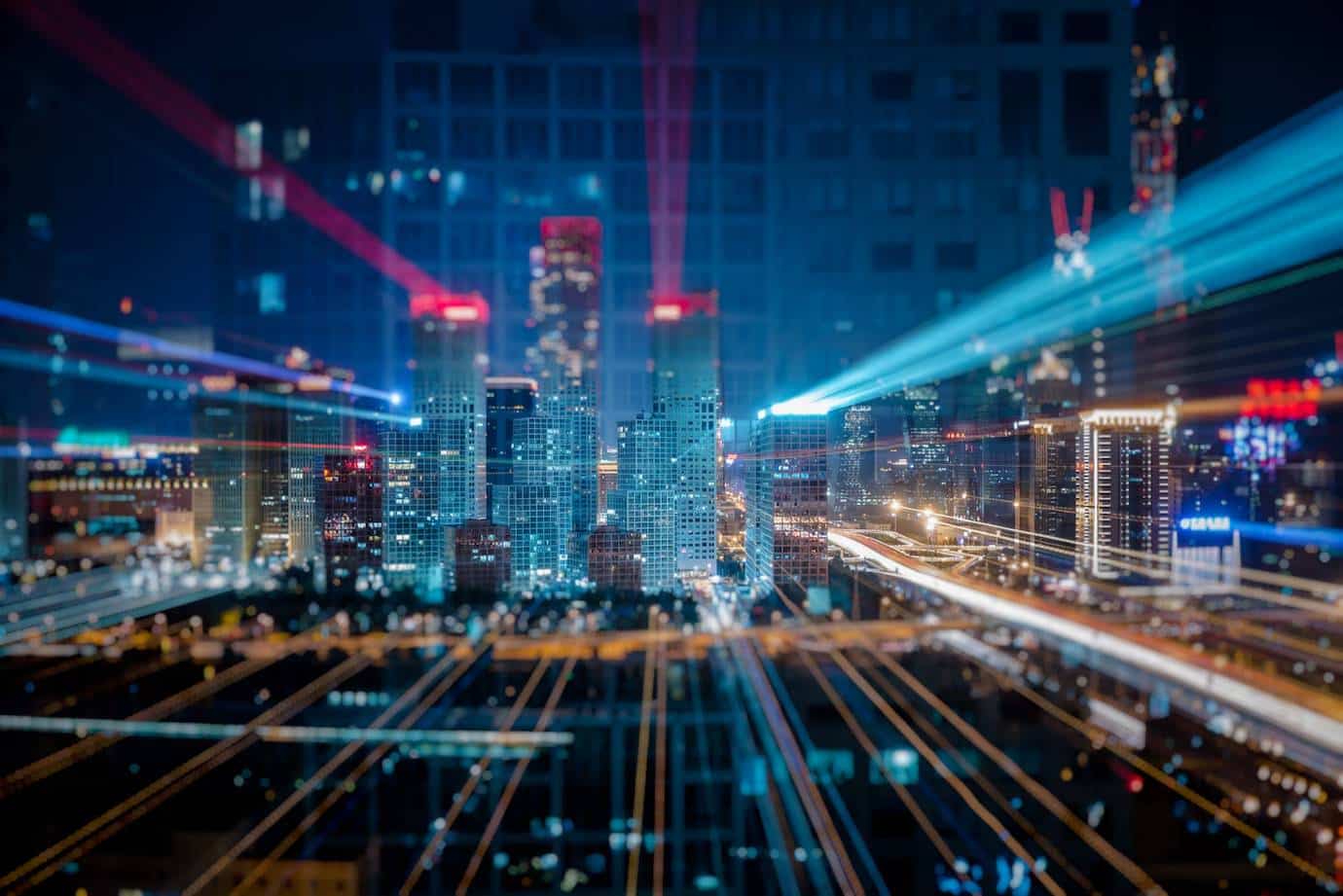 Smart city skyline at night with illuminated buildings and dynamic light trails from traffic , creating a vibrant urban atmosphere.