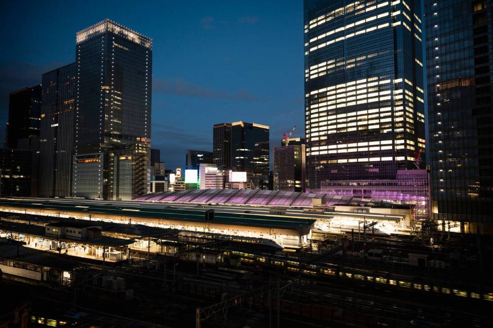 A vibrant cityscape at night, Smart Buildings and Infrastructure.
